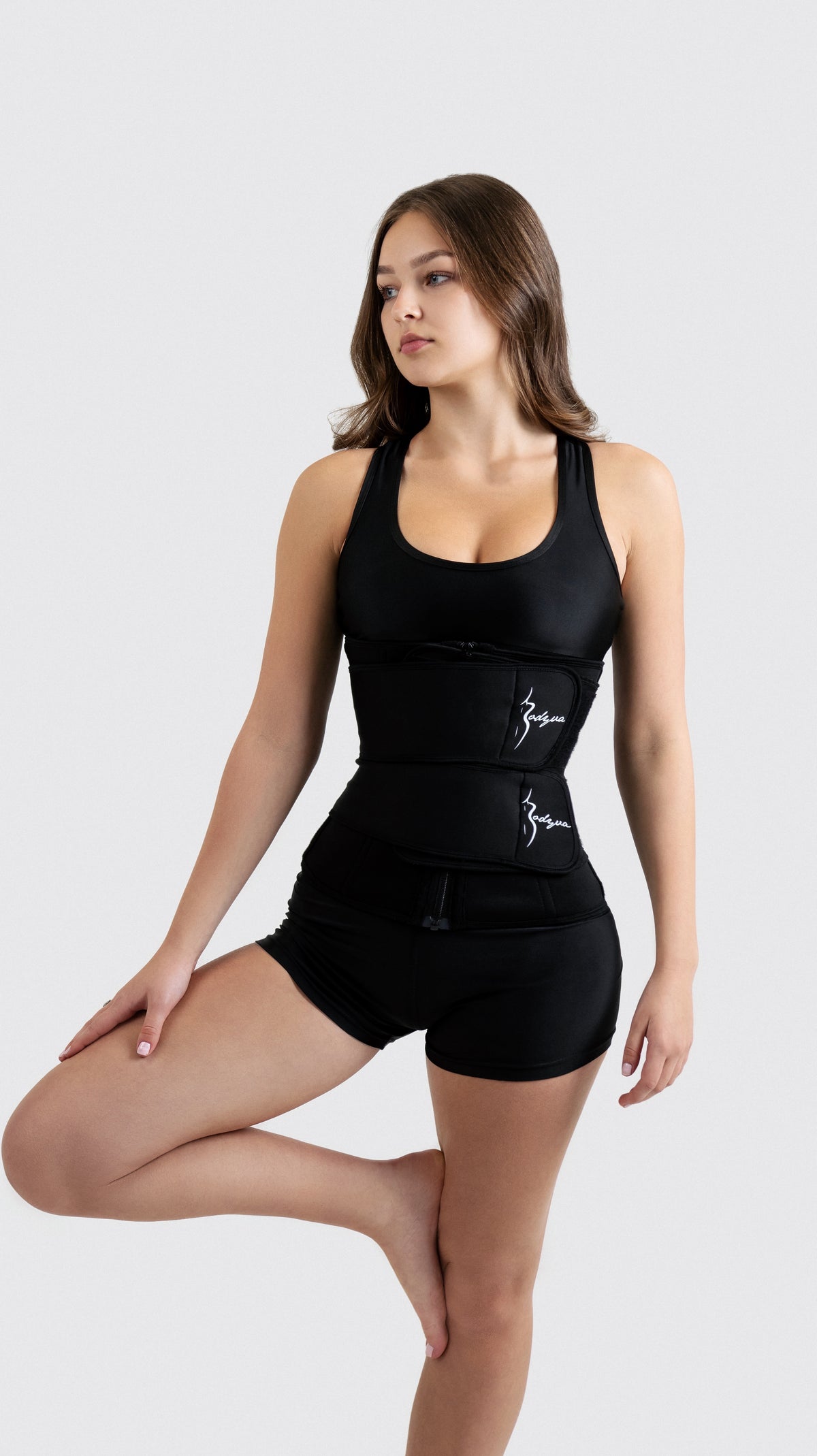 The Bodyva Waist Trainer in black with front zip and adjustable straps